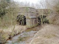 I assume the bridge was built this way because the track is on a tight curve at this spot. It's difficult to get a clear shot of all three arches without the aid of a chainsaw..