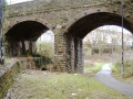 Looking under the much patched-up and strengthened original railway viaduct. The old course of the river is clearly visible.