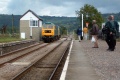 The same two engines passing the signal box at the north end of the station.