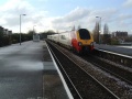 The Voyager leaves the station and crosses the bridge at Windmill Hill. The big red brick building in the right-background is where Mr Cameron makes his world famous balloons.