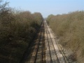 Looking west along the line, back towards Bristol. The first bridge in this photo carries the River Frome across the railway.