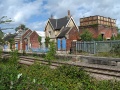 The remains of Charfield station as viewed, through some bushes, from Little Bristol Lane.