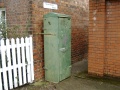 An electrical cabinet stashed away behind the platform shelters.