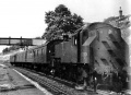 82004 stands at the station during August 1965. The footbridge is visible behind the loco. © Robin Summerhill