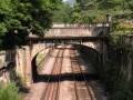 The road carrying Raby Villa across the railway as viewed from Sydney Gardens East Tunnel. Sydney Gardens are visible through the arch.