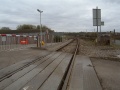 Looking south along the line with the start of the track for the Westerleigh Oil Terminal complex and a track machine in view. On the right of the photo is an original Midland Railway mileage post. It reads 122 (and a quarter) miles. The distance is from Derby.