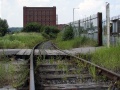 Cumberland Siding level crossing is at the west end of Cumberland Road. There used to be a siding from here which passed just behind the bonded warehouse in the background. The main route curves further around the back.