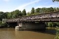 The bridge viewed from the banks of the River Avon. Kelston Park is just visible on the hill behind.