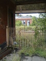 The Down platform building viewed through a locked gate.