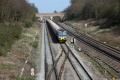 The view west. An unidentified Class 59 passes under the bridge at Stanlake Lane.