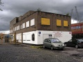 The entrance to the site of the Western Fuel Company Coal Concentration Depot. The site was in use as a pay and display car park, while the Western Fuel Co. office block is boarded up and derelict.