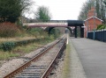 A look along the length of the platform. The disused Down platform is overrun with greenery.