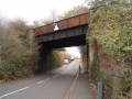 The other side of the bridge which is starting to rust rather badly. Notice how the road dips in order to get it underneath the railway.