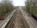 Looking south from the footbridge. The down main has a warning beacon on it. The platforms narrow where the station crosses the River Brue. The up goods loop is bi-directional and can be used by trains travelling south.