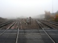 The view east. The tracks curving around to the left are for trains heading north, while those on the right pass under the A4302 Metz Way before heading south.