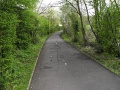 The view in the opposite direction. The route curves sharply to the right to negotiate its way around a housing estate that has been partly built on the trackbed.