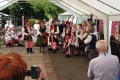 Members of the Bristol Polish community sing traditional songs while wearing traditional dress.