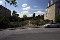 The view towards Bristol showing the trackbed passing through a gap in the housing and crossing Station Road.