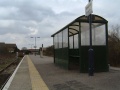 Looking along the platform taking in the platform shelter and station paraphernalia.