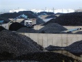 Coal as far as the eye can see... (well, as far as those petrol storage tanks anyway..) A truck is loaded for a local delivery.