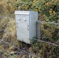 A small electrical cabinet on the right-hand side of the approach path.