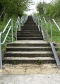The railway path is reached by climbing this set of steps.