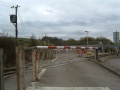 A view of the road crossing. It leads to a small carpark.