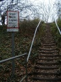 Approaching the crossing from a footpath that starts behind the Church of St James in Iron Acton.