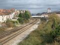 The view from Parson Street roadbridge back towards the footbridge at Malago Vale. The new-build houses on the site of the old carriage sidings are protected from noise from the railway by a bloody big wall.