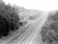 The view in 1986. The down platform and signal box have gone and the station buildings are in use by Wintle's Coal Merchants who are using them as offices. © Peter Rendall