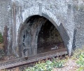 A close up that really shows off the patchwork of bricks used during repairs. Also note the writing inside the arch of the bridge. This relates to the cant of the track.
