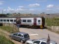An unidentified 158 heads across the crossing with a service for South Wales. © Andy Spencer