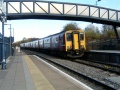 A general view of the footbridge with a Class 150 passing through.