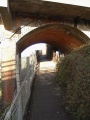 The view through the bridges of the path as it rises up to road level.