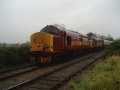 37410 takes charge of the train in the driving rain.