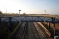 The view south from the bridge is dominated by the station's footbridge.